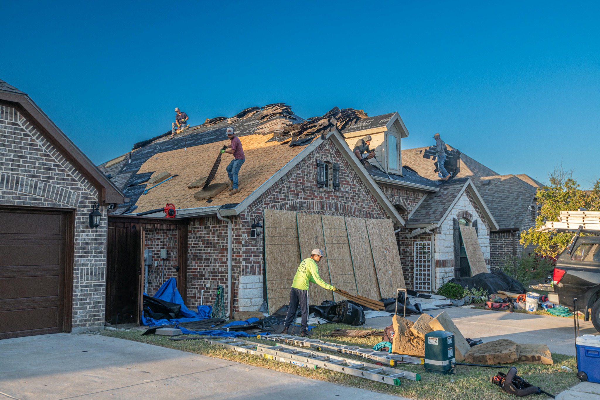 Roofing crew replacing residential roof